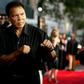 Boxing legend Muhammad Ali (R) jabs at photographers while arriving at the Orpheum Theatre for the premiere of the film "Collateral" in Los Angeles in this August 2, 2004 file photo. REUTERS/Robert Galbraith/File Photo