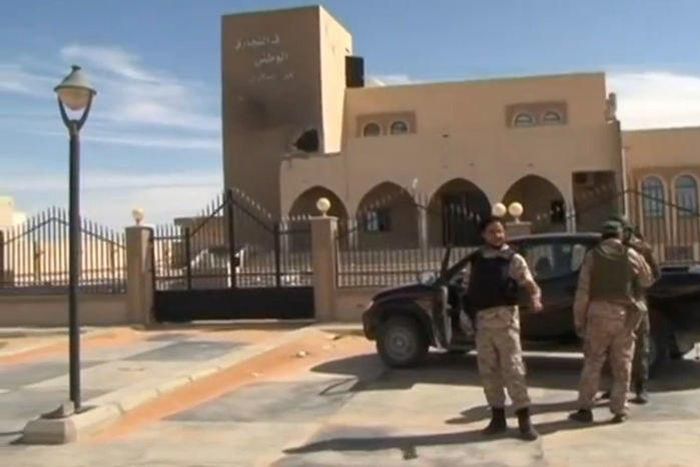 A still image from video released May 17, 2016 shows forces loyal to Libyan unity government outside the National Commercial bank after the recapture of Abu Grain, one of the main checkpoints south of the city of Misrata, Libya from Islamic State.