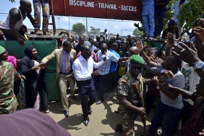 Benin Presidential candidate Patrice Talon (C, in white) arrives at a polling station during presidential elections in Cotonou, Benin, March 20, 2016. REUTERS/Charles Placide Tossou