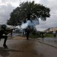 A riot policeman lobs a teargas canister to disperse supporters of the opposition Coalition for Reforms and Democracy (CORD), during a protest at the premises hosting the headquarters of Independent Electoral and Boundaries Commission (IEBC) to demand ...