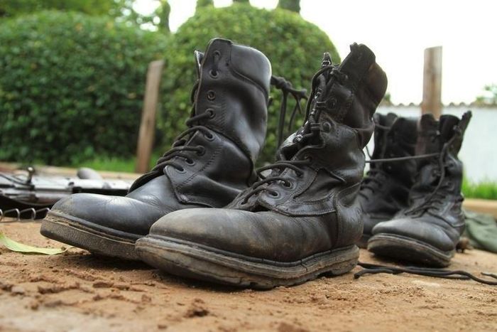 Military boots are displayed after they were recovered from suspected fighters following clashes in the capital Bujumbura, Burundi December 12, 2015. REUTERS/Jean Pierre Aime Harerimana