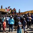 Locals attempt to gain access to a shop before looting during protests in Atteridgeville, a township located to the west of Pretoria, South Africa June 21, 2016.
