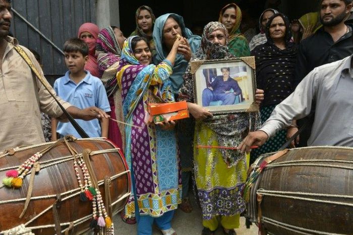Relatives of Pakistani national Zulfiqar Ali, who was sentenced to death in 2005 for heroin possession, celebrate in Lahore after the Indonesian government halted his execution