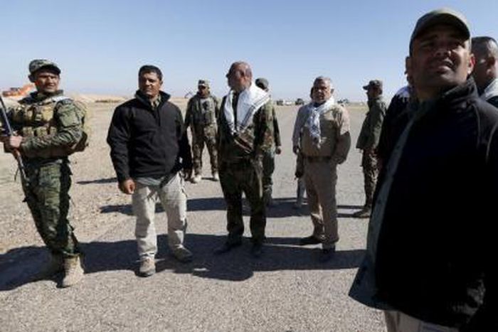 Head of the Badr Organisation Hadi al-Amiri (2nd R) stands with Shi"ite fighters during a military operation in the west of Samarra, in the desert of Anbar, March 7, 2016.