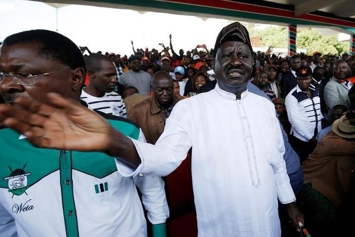 Leaders of Kenya's opposition Coalition for Reforms and Democracy (CORD), Raila Odinga (R) and Moses Wetangula (L) arrive at a rally to mark Kenya's Madaraka Day, the 53rd anniversary of the country's self rule, at Uhuru Park grounds in Nairobi, Kenya,...