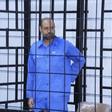 Saif al-Islam Gaddafi, son of late Libyan leader Muammar Gaddafi, attends a hearing behind bars in a courtroom in Zintan, June 22, 2014 .