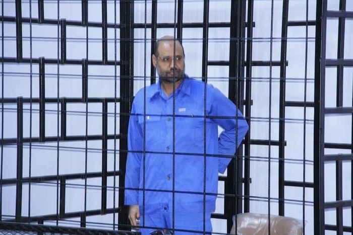 Saif al-Islam Gaddafi, son of late Libyan leader Muammar Gaddafi, attends a hearing behind bars in a courtroom in Zintan, June 22, 2014 .