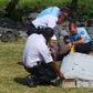 File picture shows French gendarmes and police inspecting a large piece of plane debris which was found on the beach in Saint-Andre, on the French Indian Ocean island of La Reunion, July 29, 2015.