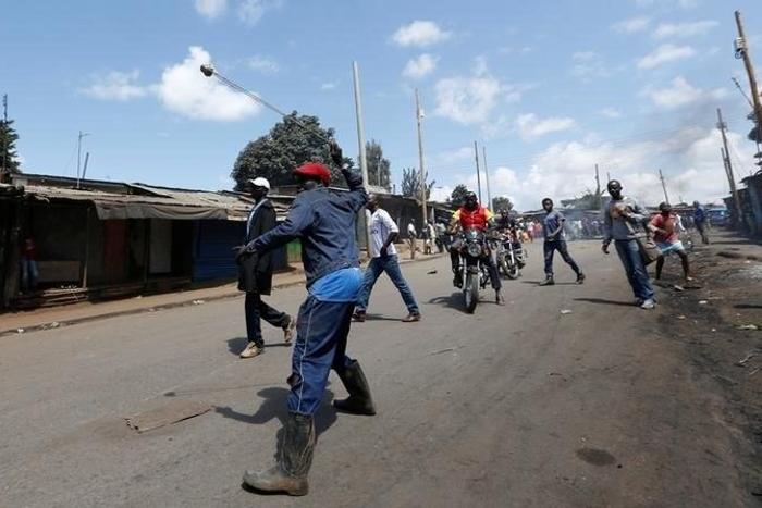 A supporter of Kenya's opposition Coalition for Reforms and Democracy (CORD) uses a sling to hurl stones towards their opponents during a protest against at the Independent Electoral and Boundaries Commission (IEBC) to demand the disbandment of the ele...