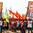 An opposition supporter holds up a banner during a rally organised by political opposition parties in Kinshasa on July 31, 2016 