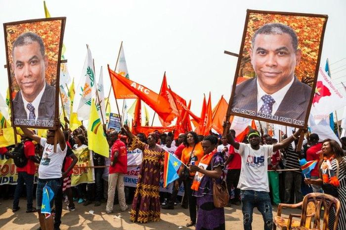 An opposition supporter holds up a banner during a rally organised by political opposition parties in Kinshasa on July 31, 2016 