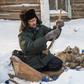 Prokopy Nogovitsyn shows part of a mammoth skeleton in the backyard of his house in a village in the northern Siberian region of Yakutia