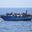 Migrants are seen on a capsizing boat before a rescue operation by Italian navy ships "Bettica" and "Bergamini" (unseen) off the coast of Libya in this handout picture released by the Italian Marina Militare on May 25, 2016.