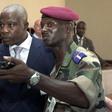 Former Ivory Coast Defense Minister Kadet Gahie Bertin (L) is assisted by a FANCI officer in this 2003 file photo.