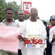 Vetran Nollywood actor, Bruno Iwoha carrying Prince Jame Uches' photograph during the rally in Abuja (Pulse)