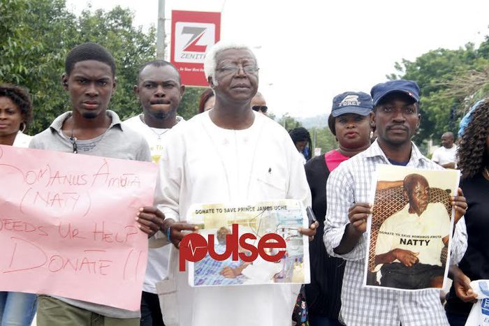 Vetran Nollywood actor, Bruno Iwoha carrying Prince Jame Uches' photograph during the rally in Abuja (Pulse)