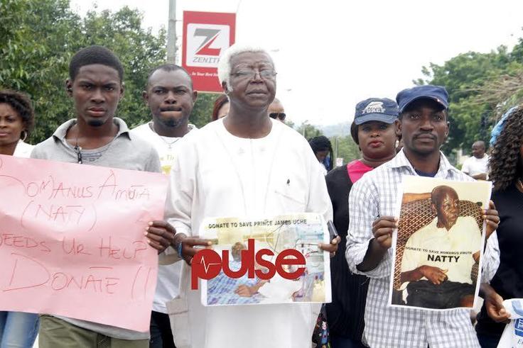 Vetran Nollywood actor, Bruno Iwoha carrying Prince Jame Uches' photograph during the rally in Abuja (Pulse)