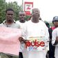 Vetran Nollywood actor, Bruno Iwoha carrying Prince Jame Uches' photograph during the rally in Abuja (Pulse)