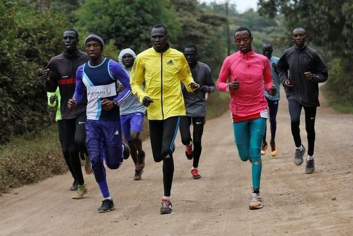 Athletes from South Sudan, part of the refugee athletes who qualified for the 2016 Rio Olympics, and their training partners run along a dusty road during a jogging session at their camp in Ngong township near Kenya's capital Nairobi, June 9, 2016.