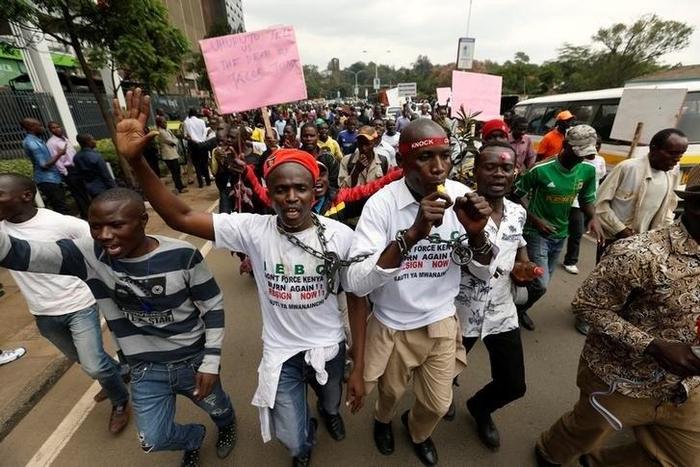 Kenyan opposition Coalition for Reforms and Democracy (CORD), supporters protest at the premises hosting the headquarters of Independent Electoral and Boundaries Commission (IEBC) to demand the disbandment of the electoral body ahead of next year's ele...