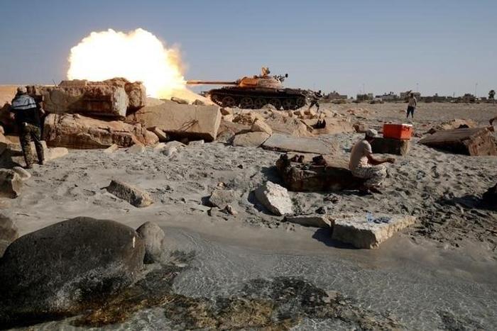 A fighter of Libyan forces allied with the U.N.-backed government fires a shell with Soviet made T-55 tank at Islamic State fighters from a beach in Sirte, Libya, August 3, 2016.