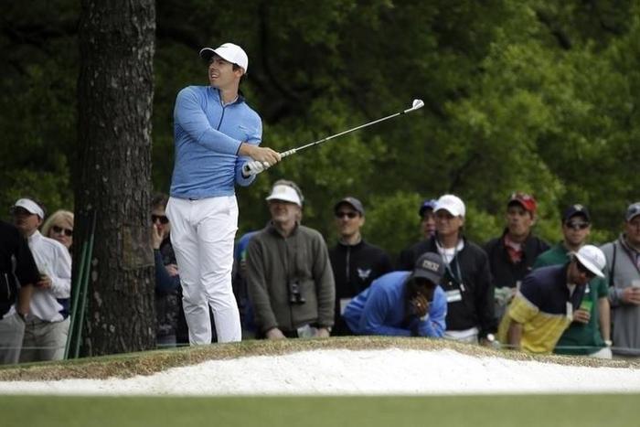 Rory McIlroy watches his second shot on the 1st hole during the final round of the 2016 The Masters golf tournament at Augusta National Golf Club. Apr 10, 2016; Augusta, GA, USA;