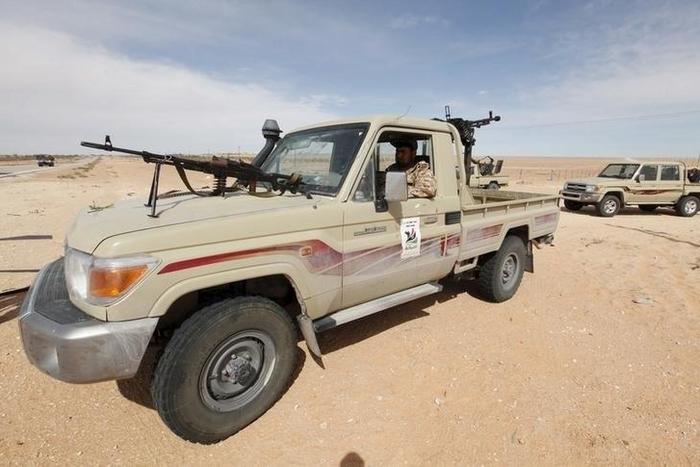 A Libyan soldier sits in a military vehicle at checkpoint in Wadi Bey, west of the Islamic State-held city of Sirte, February 23, 2016.