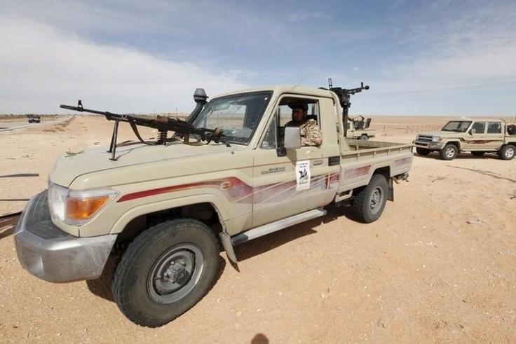 A Libyan soldier sits in a military vehicle at checkpoint in Wadi Bey, west of the Islamic State-held city of Sirte, February 23, 2016.