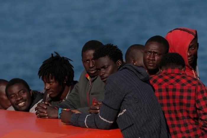 Migrants, who are part of a group intercepted aboard a makeshift boat off the coast in the Mediterranean sea, stand on a rescue boat upon arriving at a port in Malaga, southern Spain, May 19, 2016.