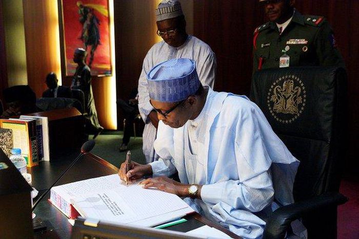 President Muhammadu Buhari signs condolence register for late Minister of State for Labour and Productivity, James Ocholi on March 9, 2016
