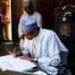 President Muhammadu Buhari signs condolence register for late Minister of State for Labour and Productivity, James Ocholi on March 9, 2016
