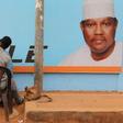 A man gets a haircut and a shave in front of a campaign poster of incarcerated opposition candidate Hama Amadou in Niamey, Niger, February 15, 2016. Niger holds presidential and legislative elections on Sunday.