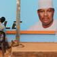 A man gets a haircut and a shave in front of a campaign poster of incarcerated opposition candidate Hama Amadou in Niamey, Niger, February 15, 2016. Niger holds presidential and legislative elections on Sunday.