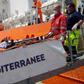 A migrant receives help when disembarking from the SOS Mediterranee ship Aquarius at the Italian island of Lampedusa in this handout received April 18, 2016.