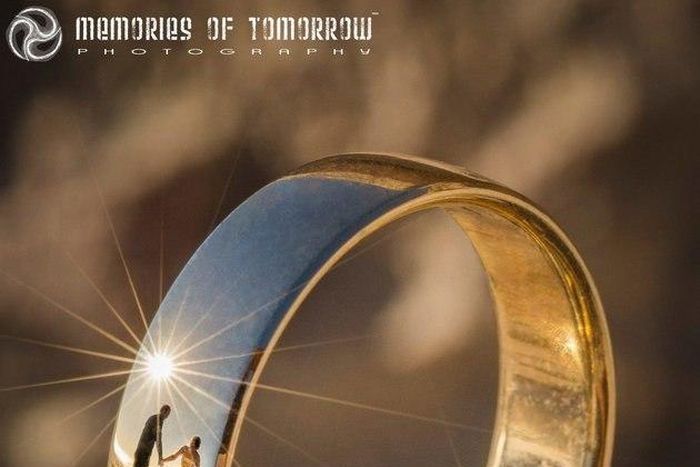 Photographer takes shots of newlyweds using wedding rings