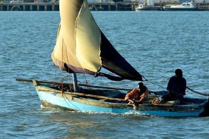 A fisherman bails out his boat in Maputo, Mozambique, May 18, 2016.