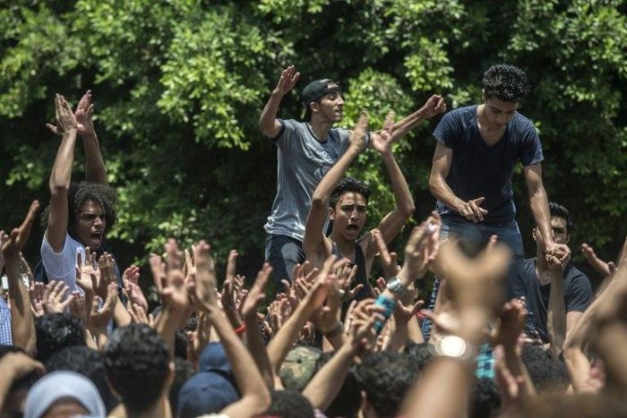 Egyptian students shout slogans during a demonstration against the education minister and the education system outside the Ministry of Education in the capital Cairo on June 27 