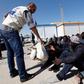 Migrants receive emergency relief in a port, after being rescued at sea by Libyan coast guard, in Tripoli, Libya April 11, 2016.