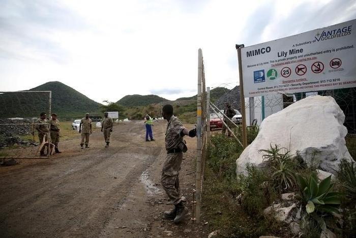 Security guards keep watch at the entrance of the Lily mine, which is owned by Vantage Goldfields, near Barberton, east of Johannesburg, February 5, 2016.