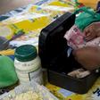 An informal trader counts out change in her cash box at her stall in Hillcrest, west of Durban, South Africa, January 11, 2016.