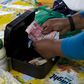 An informal trader counts out change in her cash box at her stall in Hillcrest, west of Durban, South Africa, January 11, 2016.