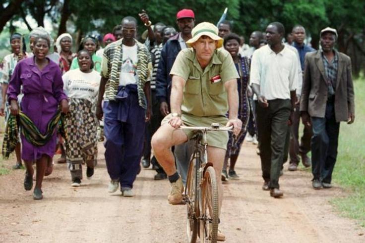 Zimbabwean commercial farmer Tommy Bayley rides an old bicycle ahead of war veterans and villagers, who invaded his farm at Danbury Park outside the capital