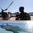 A Brazilian soldier stands guard near a A-29 Super Tucano during the opening ceremony of the Santiago's Aviation Fair, known as FIDAE, at Chile's international airport, file.