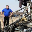 Russian Emergencies Minister Vladimir Puchkov looks at debris from a Russian airliner at its crash site at the Hassana area in Arish city, north Egypt, November 1, 2015. REUTERS/Mohamed Abd El Ghany