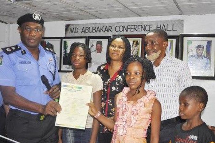 Mr. Owoseni Fatai, presenting the scholarship to the 4 children of the late Mrs Idongesit Ekpo