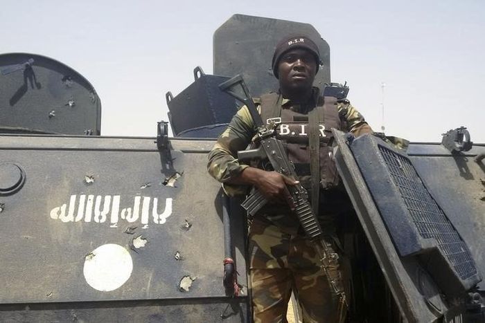 A Cameroonian soldier stands on a Nigerian armoured vehicle used by Boko Haram insurgents to attack a Cameroon army patrol near Waza, February 17, 2015. REUTERS/Bate Felix Tabi Tabe