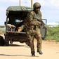 A Kenya Defense Force soldier runs for cover near the perimeter wall where attackers are holding up at a campus in Garissa April 2, 2015. A REUTERS/Noor Khamis