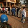 A United Nations security officer keeps guard as people wait in line to cast their votes during the second round of presidential and legislative elections in the mostly Muslim PK5 neighbourhood of Bangui, Central African Republic, February 14, 2016. RE...