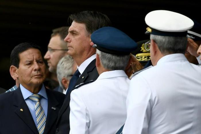President Jair Bolsonaro (2-L), seen here at the swearing-in of Brazil's new air force chief, has ordered troops to the violence-wracked northeast in a test of his campaign pledge to crack down on crime