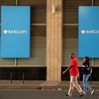 A couple walks past a Barclays logo in Johannesburg December 16, 2015. REUTERS/Siphiwe Sibeko
